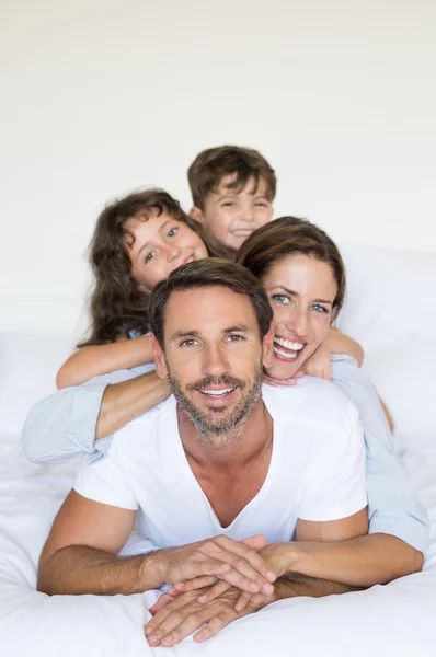 Happy family on bed — Stock Photo, Image