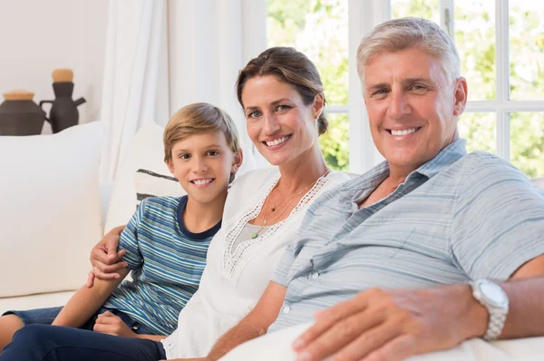 Família sentada no sofá — Fotografia de Stock