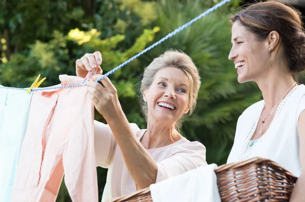 Mother daughter doing laundry