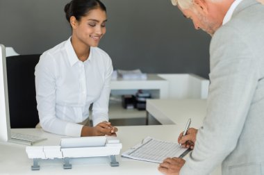 Businessman signing employee sheet clipart