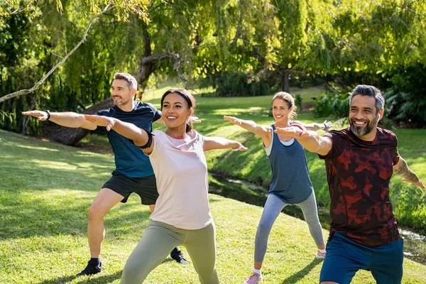 Mature Multiethnic Couple Doing Sport Physical Exercises Outdoor Friends Group — Stock Photo, Image