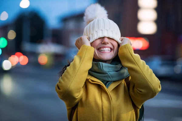 Young Playful Woman Covering Eyes Winter Cap City Street Laughing — Stock Photo, Image