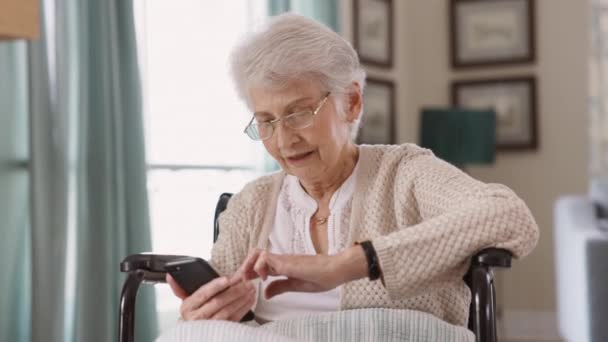 Elderly Woman Wearing Spectacles Sitting Wheelchair Using Smart Phone Happy — Stock Video