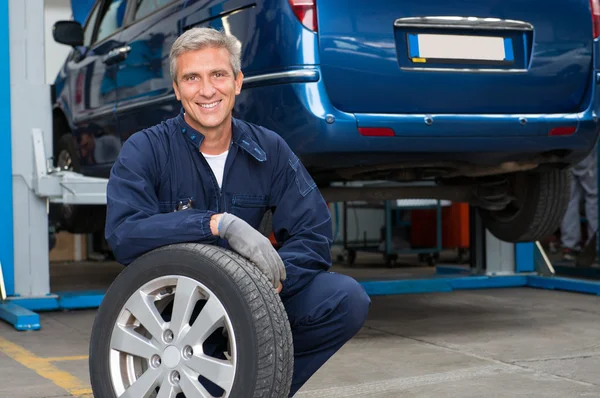 Tyre Dealer Holding A Tire — Stock Photo, Image