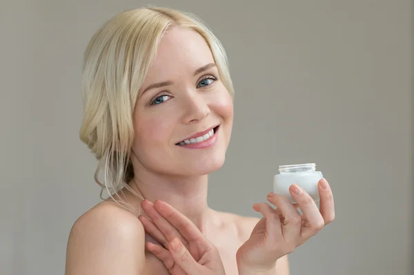 Woman holding body's moisturizer — Stock Photo, Image