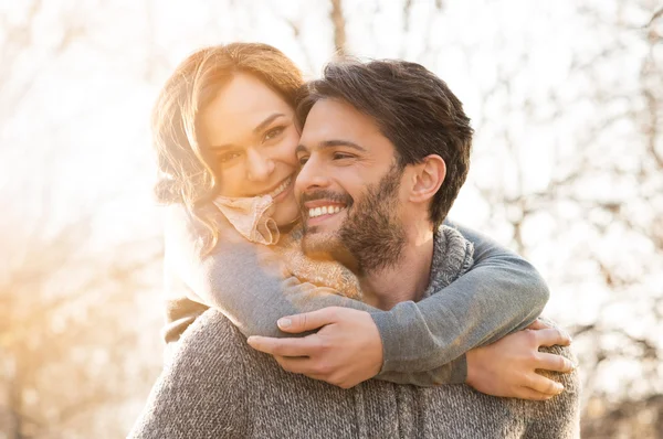 Happy couple piggyback — Stock Photo, Image