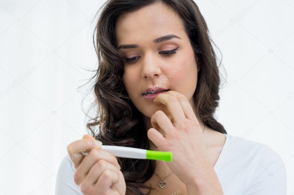 Woman looking at pregnancy test