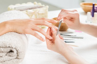 Manicure treatment at nail salon clipart