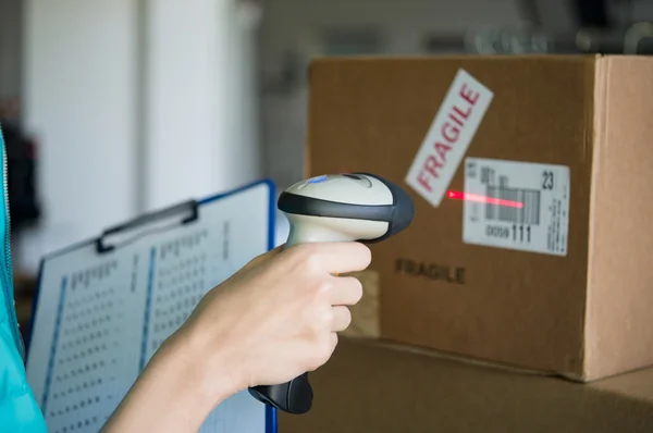 Worker scanning boxes barcode — Stock Photo, Image