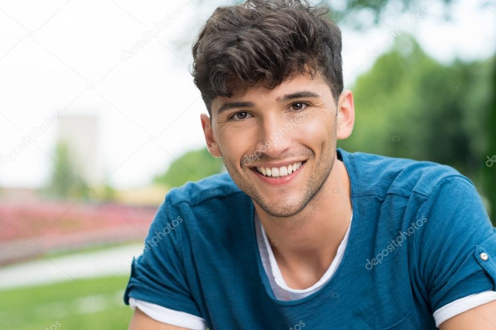 Happy guy smiling in park