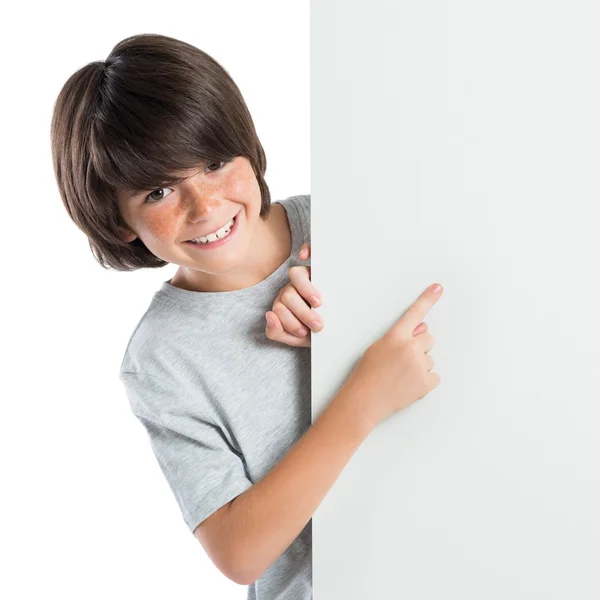 Boy pointing at empty placard Stock Image