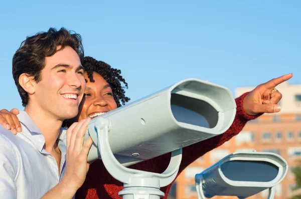 Young couple with binoculars — Stock Photo, Image