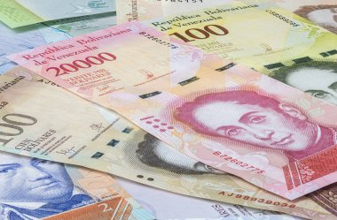 Close up to the currency of the south American country Venezuela. High inflation and weak economy increases the denomination of the banknotes. Bolivares or Bolivar money of the republic Venezuela  clipart