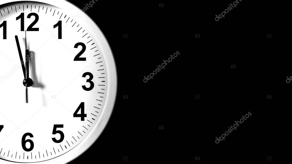 White clock face of a Wall Clock show the time. It's almost 12 o'clock. The latest report of the atomic scientist shows the doomsday clock 100 seconds to twelve.  Time is running out for mankind.