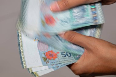 Malezya Ringgit 'ini sayan kadın eller. 50 Ringgit, Malezya 'daki en yüksek kullanılan Ringgit banknotunun peşinde. Kadın eli Ringgit para biriminin son halini sayar. RM Elli.