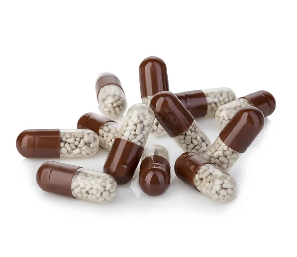 Brown capsules, pills close-up on a white background. — Stock Photo, Image