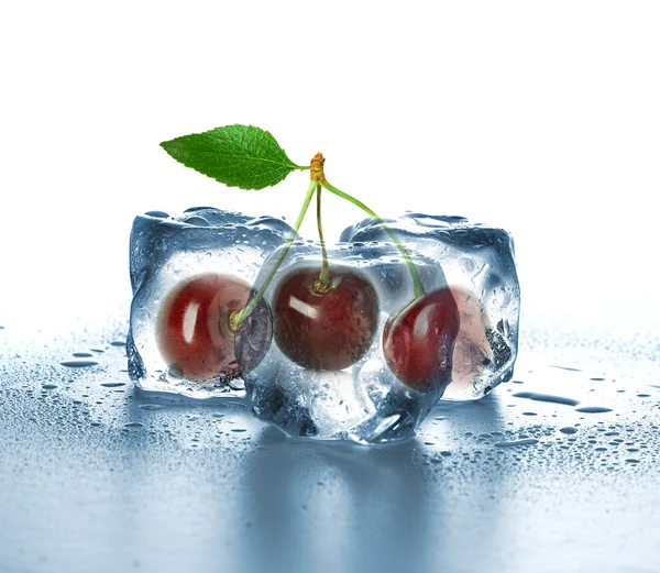 Ice cubes and sweet cherry on white background. — Stock Photo, Image