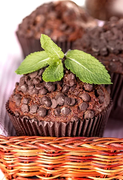 Homemade chocolate muffins in paper cupcake holder on a wooden background — Stock Photo, Image