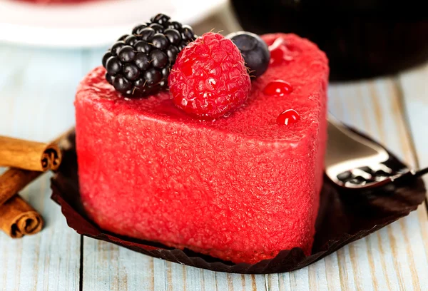 Pink cake with berries on wooden background — Stock Photo, Image