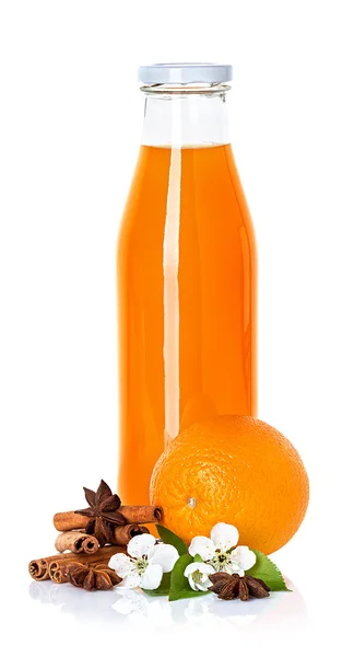 Orange juice in a bottle, orange, anise and cinnamon isolated — Stock Photo, Image