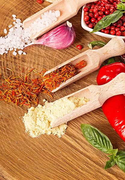 Spices and seasonings on a wooden background — Stock Photo, Image