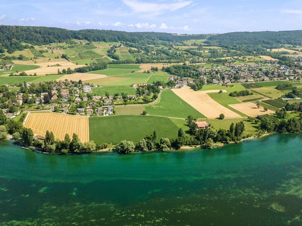 Aerial drone image of village and farming land at the blue Rhine river side in Europe
