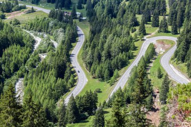Curvy Maloja pass road in summer, Canton Grisons, Switzerland. It is one of the most spectacular pass drive road in Alps mountains.
