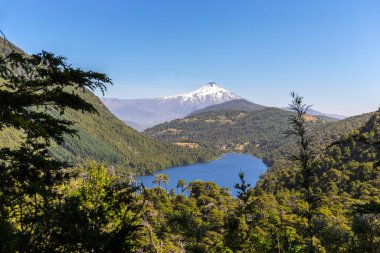 Tinquilco Lake with Villarica Volcano at the background, view edfrom Huerquehue National Park, Pucon, Chile. clipart