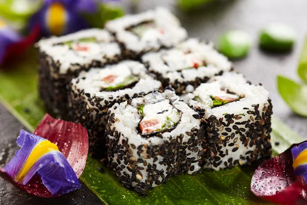 Sushi maki wegetariańskie - rolki wykonane z ogórka, papryki, sałatka z liści i serek wewnątrz. sezam poza — Zdjęcie stockowe