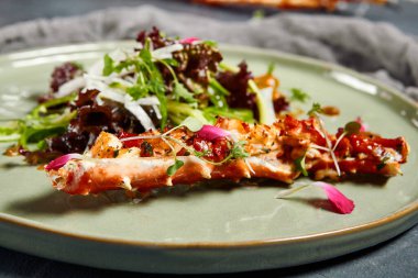 Tabaklara servis edilen lezzetli salatalar. Restoran yemekleri, yengeç etli moda salatalar, mikro yeşiller ve avokado köpüğü düz gri ahşap arka planda eski gümüş çatal bıçaklarla yatıyordu.