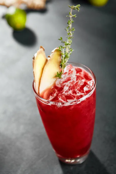 Raspberry mule cocktail. Fresh summer red drink on dark slate background. Red cocktail with ginger and rosemary