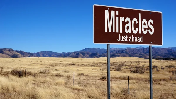 Miracles Just Ahead brown road sign — Stock Photo, Image