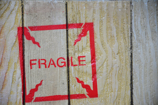 Fragile stenciled on shipping packing crate