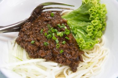 Zha jiang mian, chinese cuisine, noodles topped with fermneted soy bean paste and fresh vegetable clipart