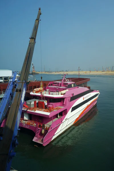 Worker loads the laggages to passenger ferry before travel to Ma