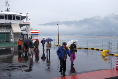 Tourist takes ferry to Miyajima, Japan clipart