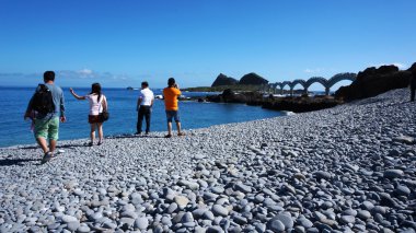 Tourists visit the famous beach at Sanxiantai clipart