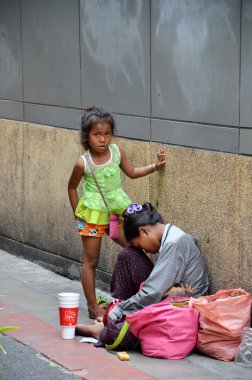 Beggars beg for money on the street clipart