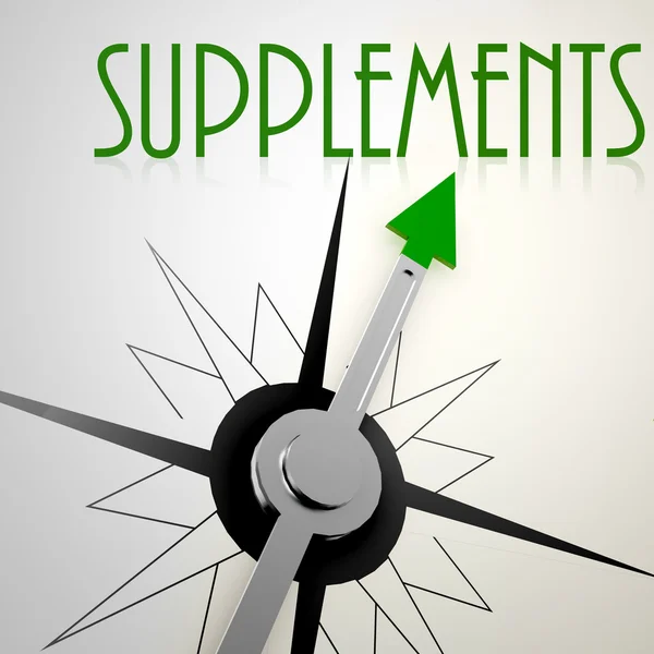 Supplements on green compass — Stock Photo, Image
