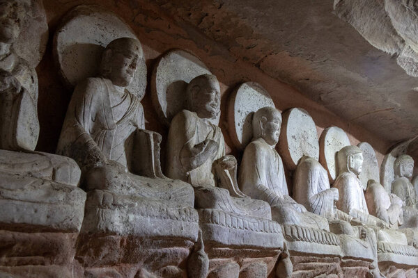 Buddha sculptures at Beishan Rock Carvings in Dazu, China. Dazu Rock Carvings have over 50,000 statues, integrating Buddhism, Daoism, and Confucianism.