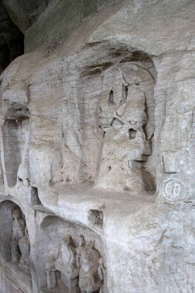 Buddha sculptures at Beishan Rock Carvings in Dazu, China. Dazu Rock Carvings have over 50,000 statues, integrating Buddhism, Daoism, and Confucianism.