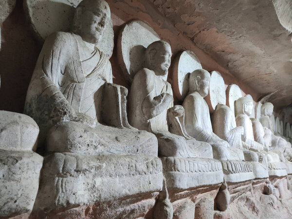 Rock sculptures of Buddha at Beishan Rock Carvings in Dazu, China. Dazu Rock Carvings have over 50,000 statues, integrating Buddhism, Daoism, and Confucianism.