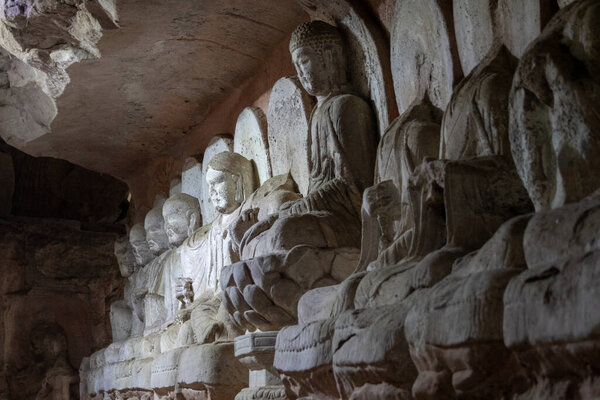 Buddha sculptures at Beishan Rock Carvings in Dazu, China. Dazu Rock Carvings have over 50,000 statues, integrating Buddhism, Daoism, and Confucianism.