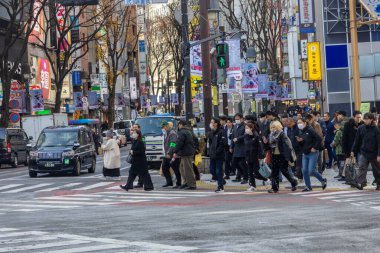 Tokyo, Japonya - 16 Aralık 2025: İnsanlar Tokyo 'nun enerjisinin gerçekten canlandığı Shibuya alışveriş alanını ziyaret ediyor. Neon ışıkları, modaya uygun dükkanlar, atari salonları ve sonsuz yiyecek seçenekleriyle doluydu.