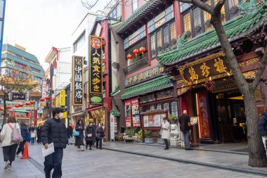 Yokohama, Japonya - 23 Aralık 2025: Yokohama, Japonya 'da Çin Mahallesi Vibrant Caddesi. Renkli kapılar ve bir dizi Çin yiyeceğiyle dolu enerjik sokaklar canlı ve hareketli bir atmosfer yaratıyor.