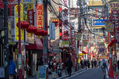 Yokohama, Japonya - 23 Aralık 2025: Yokohama, Japonya 'da Çin Mahallesi Vibrant Caddesi. Renkli kapılar ve bir dizi Çin yiyeceğiyle dolu enerjik sokaklar canlı ve hareketli bir atmosfer yaratıyor.
