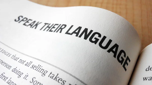 Speak their language word on a book — Stock Photo, Image