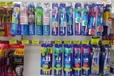 Oral care products on the shelves of a grocery store in Johor, M clipart