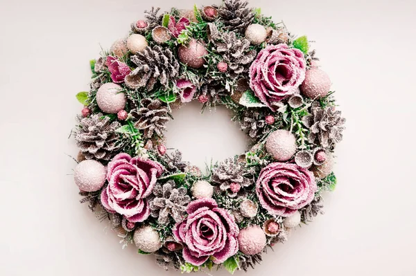 Festive background with an Advent wreath. Christmas mood. Handmade decoration with flowers and frost. Natural pink - purple color.