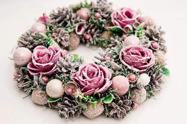 Festive background with an Advent wreath. Christmas mood. Handmade decoration with flowers and frost. Natural pink - purple color.